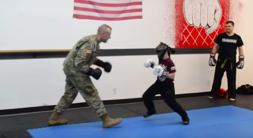 boy spars with deployed dad