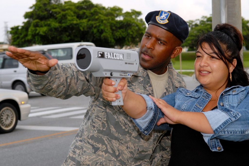 Tech. Sgt. Ronald Keeve instructs Army spouse Vanessa Chavez on the use of a speed detecting radar gun during the civilian police academy course May 27 at Kadena Air Base, Japan. Sergeant Keeve is a member of the 18th Security Forces Squadron.